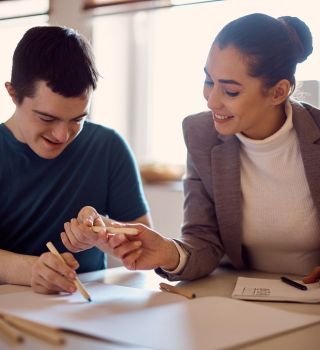 Happy,Down,Syndrome,Man,And,His,Psychologist,Drawing,Together,On